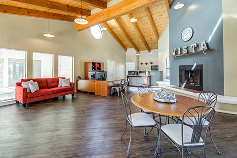 a living room with a table and chairs and a fireplace